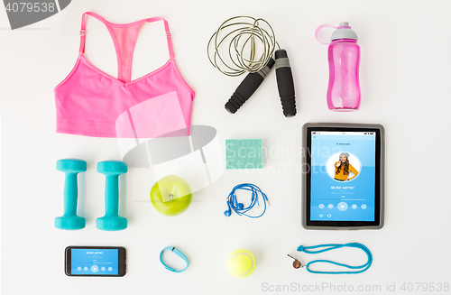 Image of close up of tablet pc, cellphone and sports stuff