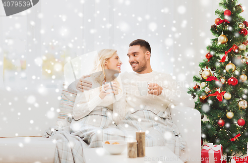 Image of happy couple at home with christmas tree