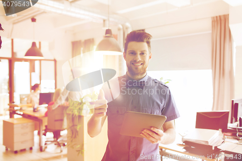 Image of happy creative male office worker with tablet pc