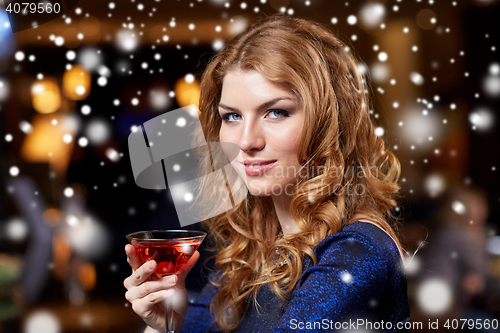 Image of glamorous woman with cocktail at night club or bar