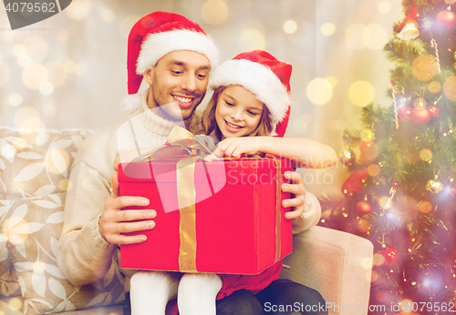 Image of smiling father and daughter opening gift box