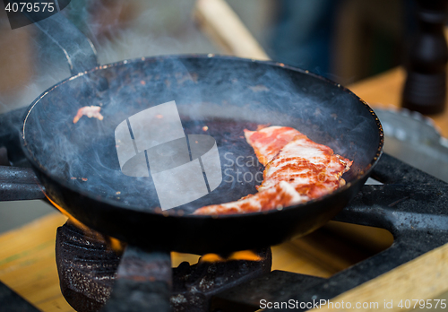 Image of close up of food frying pan at street market