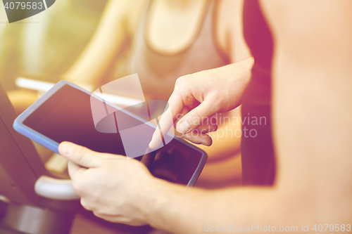 Image of close up of trainer hands with tablet pc in gym