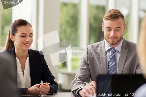 Image of smiling business people meeting in office
