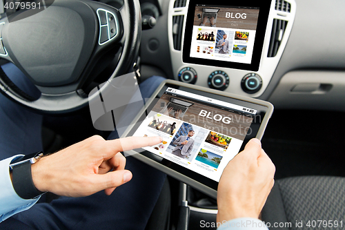 Image of close up of man with tablet pc in car