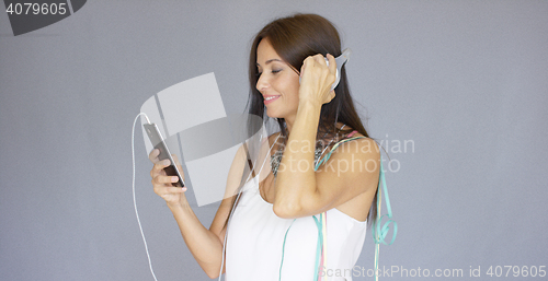 Image of Young woman listening to music at New Year