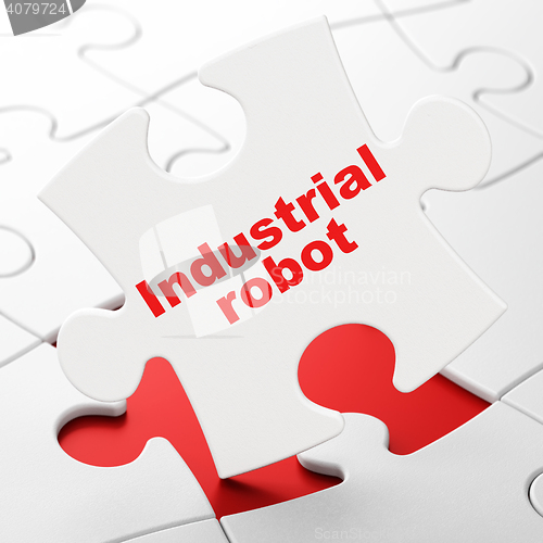 Image of Industry concept: Industrial Robot on puzzle background