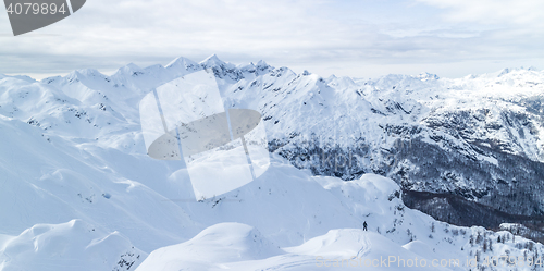 Image of Freeride snowboarder on the top of the mountain.