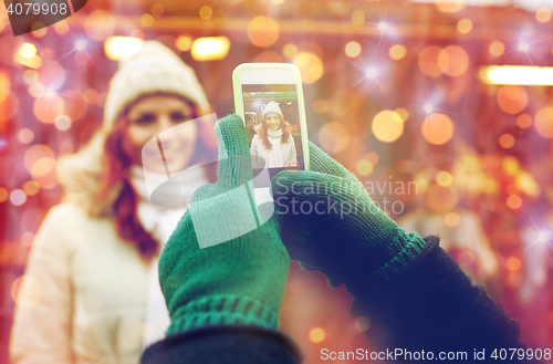 Image of couple taking picture with smartphone in old town