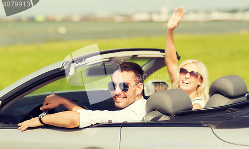 Image of happy man and woman driving in cabriolet car