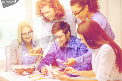 Image of smiling team with color samples at office