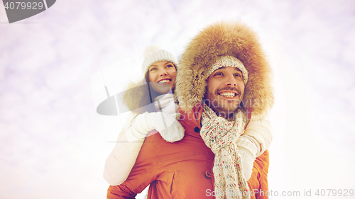 Image of happy couple having fun over winter background