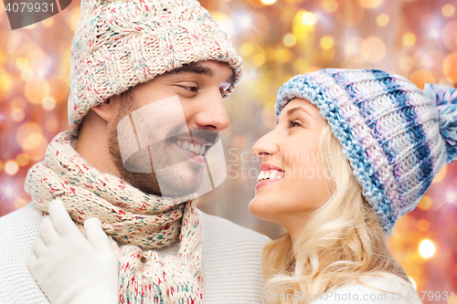 Image of close up of happy smiling couple in winter clothes