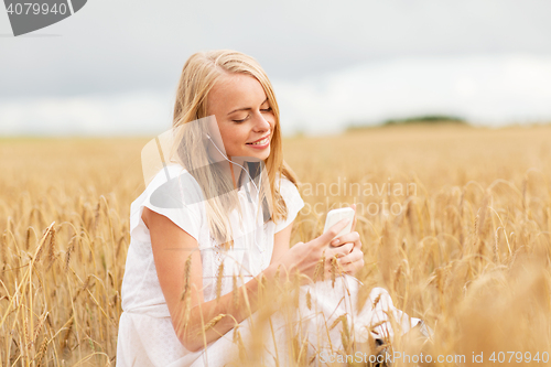Image of happy woman with smartphone and earphones