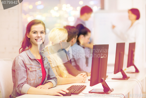 Image of smiling teenage girl with classmates and teacher