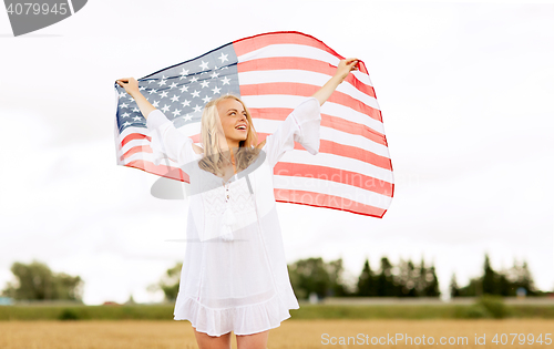 Image of happy woman with american flag on cereal field