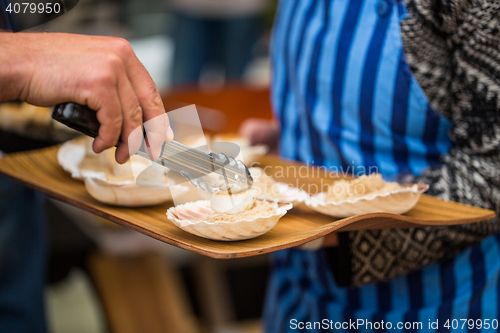 Image of close up of scallop with garnish on seashell