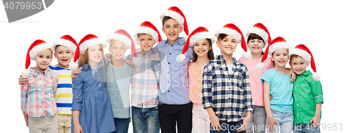 Image of happy smiling children in santa hats hugging