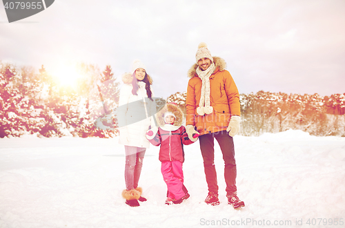 Image of happy family with child in winter clothes outdoors