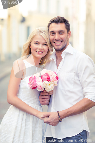 Image of couple with flowers in the city