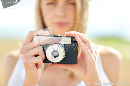 Image of close up of woman photographing with film camera