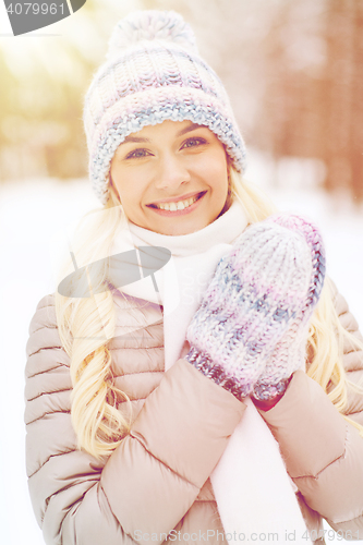 Image of smiling young woman in winter forest