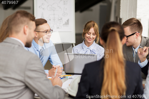 Image of architects with laptop meeting at office