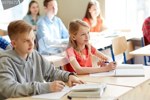 Image of group of students with notebooks at school lesson