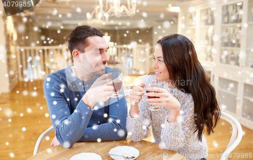 Image of happy couple drinking tea at cafe