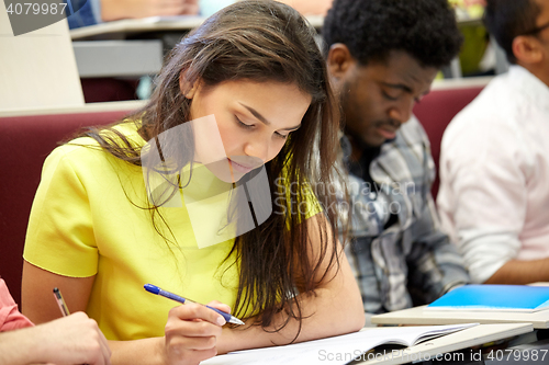 Image of group of international students writing at lecture