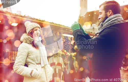 Image of couple taking selfie with smartphone in old town