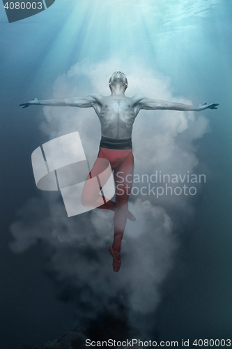 Image of Young and stylish modern ballet dancer on fantasy background