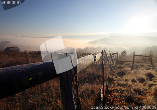 Image of sunrise with fog over field