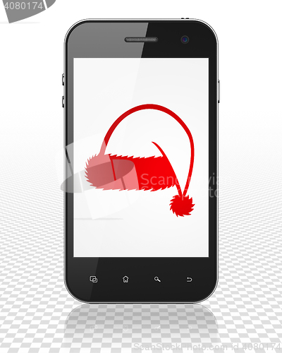 Image of Entertainment, concept: Smartphone with Christmas Hat on display