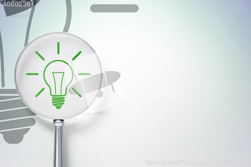 Image of Finance concept:  Light Bulb with optical glass on digital background