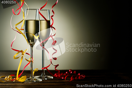 Image of Two filled champagne glass with festive decoration