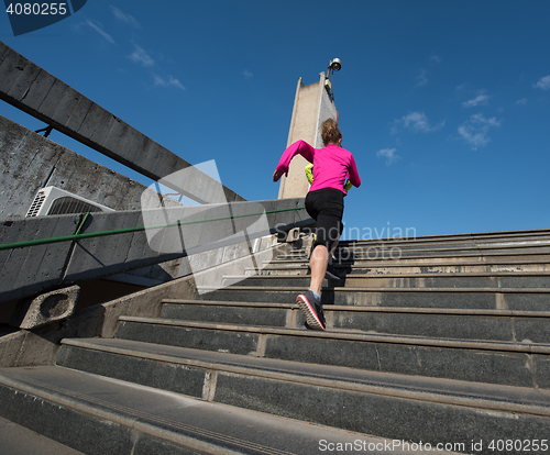 Image of woman jogging on  steps