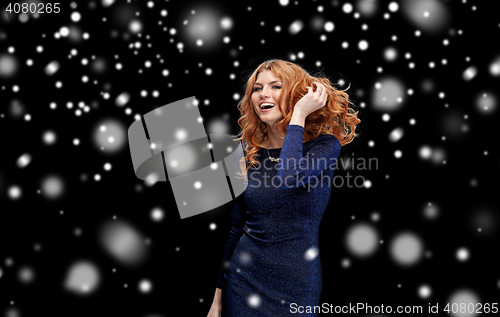 Image of happy young woman dancing at night club disco