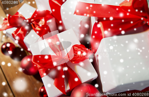 Image of close up of gift boxes and red christmas balls