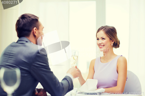 Image of couple with glasses of champagne at restaurant