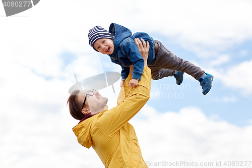 Image of father with son playing and having fun outdoors