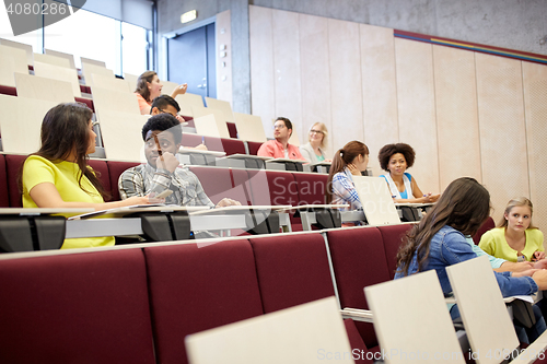 Image of group of students with notebooks at lecture hall