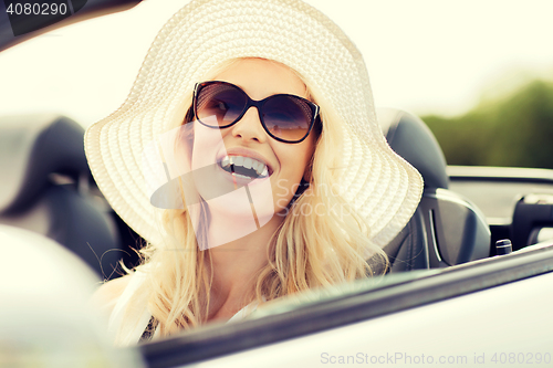 Image of happy woman driving in cabriolet car