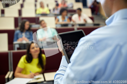 Image of teacher with tablet pc and students at lecture