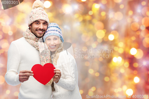 Image of smiling couple in winter clothes with red hearts