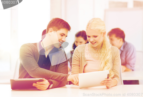 Image of students looking at tablet pc in lecture at school