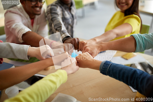 Image of close up of international students hands fist bump