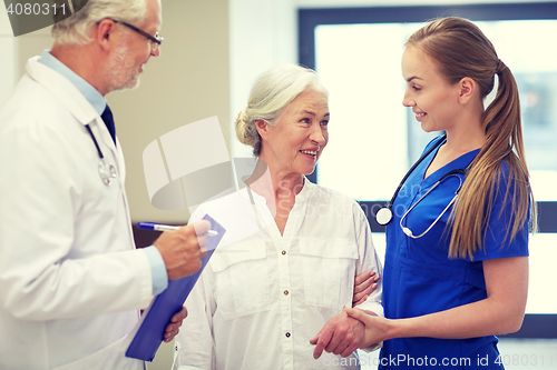 Image of medics and senior patient woman at hospital