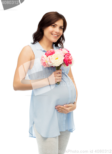 Image of happy pregnant woman with flowers touching belly