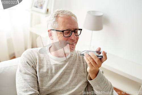 Image of old man using voice command recorder on smartphone